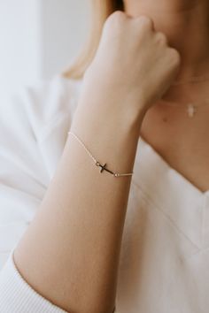 This precious cross bracelet is handcrafted with sterling silver and custom fit to your wrist, ensuring long-lasting style and quality. Invest in this timeless piece to cherish and wear for a lifetime. ∙ D E T A I L S ∙ - 6.5" plus Extension. - 925 Stamped Sterling Silver - 1mm Cable Chain - Cross Measure: 8mm ∙ STERLING SILVER ∙ Sterling silver jewellery is an excellent -high quality choice. The metal will not rust or perish, plus if you look after your jewellery it will look great well into th Silver Cross Bracelets For Gifts, Minimalist Sterling Silver Cross Bracelet, Dainty Sterling Silver Cross Bracelet, Nickel Free Sterling Silver Cross Bracelets, Silver Bracelet With Cross Pendant As Gift, Nickel-free Cross Bracelet Gift, Sterling Silver Cross Rosary Bracelet, Sterling Silver Spiritual Rosary Bracelet With Cross, Spiritual Sterling Silver Cross Rosary Bracelet