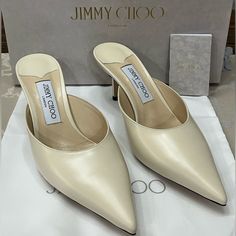 Elevate Your Shoe Game With These Stunning Jimmy Choo Rav 65mm Mules In Chalky White “Liquid” Leather. The Sleek Pointed Toe And Classic Slip-On Mule Design Make These Heels A Must Have For Any Fashion-Forward Woman. The Mid-Height Stiletto Heel Is Both Stylish And Comfortable, Perfect For A Day-To-Night Transition. These Shoes Come Brand New In Their Box With The Dust Bag, Ready To Elevate Any Outfit With Their Timeless Design. Please Review All Photos, Which Are A Part Of The Description. Happ Luxury Leather Kitten Heels With Low Heel, Chic White Kitten Heels With Leather Sole, Evening Cream Calf Leather Heels, Cream Calf Leather Heels For Evening, Luxury Kitten Heels With Heel Strap, Luxury Leather Kitten Heels For Office, Formal Cream Leather Kitten Heels, Luxury White Kitten Heels, Luxury Closed Toe Kitten Heels With Heel Strap