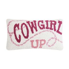 a pillow with the words cowgirl up on it's back and pink lettering