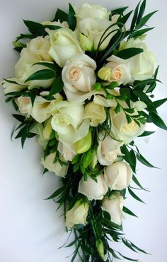 a bridal bouquet with white roses and greenery