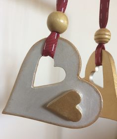 a white and gold heart hanging from a string