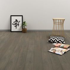 an empty room with a chair and pictures on the floor