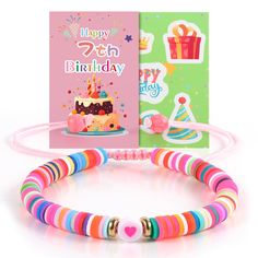 a birthday card, bracelet and greeting card with a happy birthday cake on the front