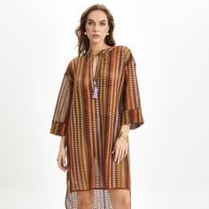 This fluid Livia tunic dress made of knitted fabric without lining. The style has a deep v-neck with a self tie bow and side slits for a comfortable use. 100% polyester V-neck Viscose Kaftan For The Beach, V-neck Cover-up For Vacation In Fall, Brown Viscose Midi Dress For Summer, Chic Beach Tunic For Fall, Chic Fall Beach Tunic, V-neck Tunic For Beach In Fall, Fall Beach Tunic With V-neck, Long Sleeve Beach Dresses With Side Slits, Fall Beach V-neck Tunic