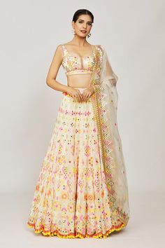 Multi color georgette flared lehenga crafted with attached can-can, all over floral, geometric pattern, multi color thread, mirror and sequin embroidery. Paired with embroidered padded blouse and embroidered dupatta.
Components: 3
Pattern: Embroidered and Printed
Type Of Work: Thread, Mirror and Sequin Work
Neckline: Round Neck
Sleeve Type: Sleeveless
Fabric: Georgette, Dupatta: Organza
Color: Multi Color
Other Details: 
Fringe drop tasselled lehenga border
Deep round back
Scalloped cut work hem Off White Lehenga For Navratri, White Georgette Lehenga With Dori Work, Off White Georgette Choli With Resham Embroidery, Off White Georgette Lehenga With Zari Work, Off White Georgette Lehenga For Festivals, Festive Off White Georgette Choli, Festive Off-white Georgette Choli, Sequins Embroidery, Cut Work