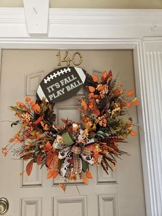 a football wreath on the front door of a house that says it's fall play time