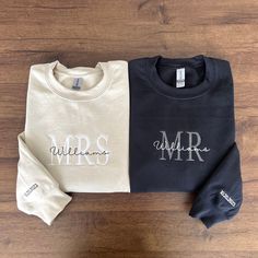 two sweatshirts with the words mr and mrs on them sitting on a wooden floor