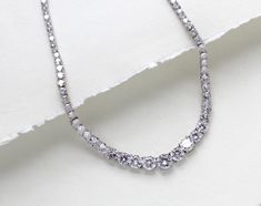 Beautiful rose gold cubic zirconia bridal tennis necklace created with Round cubic zirconia in a graduated style. This is classic style that will match any wedding gown or special occasion dress - PLEASE ALLOW APPROX 3-5 BUSINESS DAYS FOR COMPLETION BEFORE SHIPPING.- Handcrafted with Premium cubic zirconia stones - All clear stones- Rhodium, yellow gold or rose gold finish- Necklace measures 16.5 inches and extends to 18.5 inches- Nickel free and hypoallergenic This is an original design by © Treasures by Agnes FOR MATCHING PIECES SIMPLY TYPE "SOPHIE" IN THE SEARCH BAR Wedding Tennis Necklace With Brilliant Round Cut, Brilliant Cut Tennis Necklace For Wedding, Single Strand Round Tennis Necklace For Wedding, Single Strand Tennis Necklace For Wedding, Wedding Cubic Zirconia Single Strand Tennis Necklace, Wedding Tennis Necklace With Single Strand Cubic Zirconia, Wedding Tennis Necklace With Brilliant Cut Cubic Zirconia, Brilliant Cut Cubic Zirconia Tennis Necklace For Wedding, Wedding White Gold Tennis Necklace With Cubic Zirconia