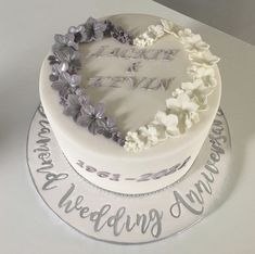 two tiered wedding cake decorated with flowers and the words love you to the moon and back