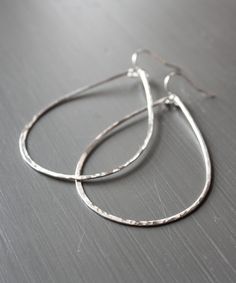 "Hammered and formed by hand, our Olivia Teardrop Earrings come with extra shimmer and in a size for everyone. This large 2.5\" size is one of Heather's Top Picks that everyone should own - they are lightweight, sturdy for travel, and a modern update to the basic hoop. To ensure the longevity of this design, all elements are made from high quality 14k Gold Filled or Sterling Silver wire that is hypoallergenic and will not flake, discolor or wear off over time. Looking for a different size? The O Hand-forged Teardrop Hoop Earrings, Modern Teardrop Hand Forged Hoop Earrings, Silver Teardrop Hand-forged Hoop Earrings, Silver Teardrop Hand Forged Hoop Earrings, Hammered Teardrop Sterling Silver Hoop Earrings, Hammered Sterling Silver Teardrop Hoop Earrings, Hand Forged Teardrop Silver Hoop Earrings, Everyday Hand Forged Teardrop Hoop Earrings, Handmade Teardrop Earrings