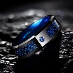 Blue & Black Tungsten Ring With an Artistic Design ✦ The width of the ring is 8mm. ✦ WHAT IS INCLUDED IN YOUR ORDER - Your Huhtala ring/rings in the size you've chosen - Lifetime warranty for the ring/rings ✦ Handcrafted in Finland, this highly durable Tungsten Carbide ring is made to last forever. ✦ Your Huhtala ring is made from the best possible materials so you don't have to worry about scratches or the ring fading. Being 100% Hypoallergenic, it will not cause skin irritation. ✦ SIZING ✦ Enj His And Hers Rings, Carbon Fiber Rings, Bracelet Viking, Celtic Dragon, Ring Man, Dragon Ring, Single Ring, Tungsten Carbide Rings, Wolfram