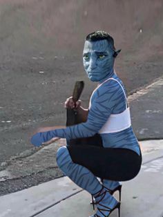 a man with blue paint on his face is holding a baseball bat and crouching down