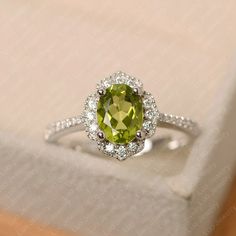 Elegant Lime Green Birthstone Promise Ring, Elegant Lime Green May Birthstone Ring, Elegant Lime Green Ring With Center Stone, Elegant Peridot Birthstone Ring With Prong Setting, Elegant Oval Peridot Diamond Ring, Elegant Lime Green Birthstone Rings, Oval Peridot Diamond Ring For Formal Occasions, Green Oval Diamond Ring In Sterling Silver, Formal Oval Peridot Diamond Ring