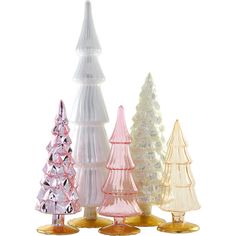 three different colored glass christmas trees sitting next to each other