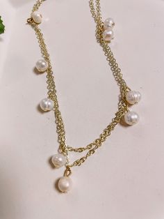 The Camille pearl necklace boasts freshwater pearls on a 32-inch chain for endless styling possibilities. It is available in 24k gold-plated or Rhodium-plated, making it an ideal accessory for any occasion. Our gold-plated chains are tarnish resistant, but require more care. Gold-plated chains can be worn for months with no tarnish, but it's not recommended to shower, sweat, or swim with them. Gold-filled chains are available for those who want more durable chains that never have to be removed. Gold Baroque Pearl Long Necklace, Gold Long Baroque Pearl Necklace, Long Pearl Pendant Chain Necklace, Long Pearl Chain Necklace With Pearl Pendant, Double Strand Pearl Necklace For Layering, Gold Pearl Pendant Necklace In 14k Gold Filled, Pearl White Baroque Pearl Jewelry With Adjustable Chain, Adjustable Baroque Pearl White Jewelry, Baroque Pearl White Jewelry With Adjustable Chain