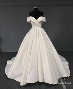 a white ball gown on a mannequin with a black bustle and neckline