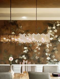 an elegant dining room with floral wallpaper and chandelier