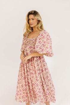 whether you’re searching for the perfect wedding guest dress, or for an excuse to feel like a princess, this puff sleeve midi dress does not disappoint. it features a stunning pink vintage floral pattern, dramatic puff sleeves, + a flirty corset-inspired bodice. the perfect long formal dress for garden parties, fancy dinners, + anytime you feel like frolicking. pink + purple floral // midi length, scoop neckline, dramatic puff sleeves, back zipper closure, smocked bodice, fully lined model is 5' Feminine Flowy Floral Dress With Puff Sleeves, Puff Sleeve Floral Dress With Smocked Bodice For Brunch, Flowy Floral Print Dress With Puff Sleeves, Flowy Floral Print Midi Dress With Puff Sleeves, Flowy Puff Sleeve Midi Dress With Floral Print, Spring Floral Print Dress With Balloon Sleeves, Feminine Flowy Puff Sleeve Dress With Floral Print, Feminine Floral Print Puff Sleeve Dress For Brunch, Feminine Floral Print Puff Sleeve Dress For Spring