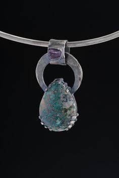 Introducing a sterling silver pendant that seamlessly merges the spiritual serenity of raw amethyst with the exotic allure of rare Himalayan turquoise, all enveloped in an oxidized, hammer-textured claw setting. a sterling silver pendant that seamlessly merges the spiritual serenity of raw amethyst with the exotic allure of rare Himalayan turquoise, all enveloped in an oxidized, hammer-textured claw setting. ----------------------------- << You will receive the Piece depicted in the listing >> < Healing Jewelry With Large Pendant, Healing Large Pendant Jewelry, Amulet Style Jewelry With Teardrop Gemstone, Amulet Style Teardrop Gemstone Jewelry, Spiritual Large Stone Pendant Jewelry, Spiritual Jewelry With Large Stone Pendant, Spiritual Teardrop Pendant Large Jewelry, Spiritual Pendant Jewelry With Large Stone, Chrysocolla Gemstone Oval Pendant Jewelry