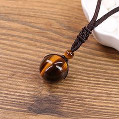 Not only does the Natural Tiger Eye Stone Pendant and Weave Necklace look great and make the perfect gift for someone. The Tiger Eye represents the power, courage and fearlessness of the tiger. Tigers Eye is a must have if you are looking for balance and harmony in your life and will improve your sense of self-worth. You will feel empowered and confident and it can strengthen your willpower and your intention to succeed. It’s considered to be a protector of the wearer’s resources, bringing prosp Spiritual Brown Crystal Necklace Gift, Spiritual Brown Necklace Perfect For Gifts, Delicate Gold Chain, Brown Tiger, Bracelet Viking, Brown Tiger Eye, Woven Necklace, Tigers Eye Necklace, Protection Necklace