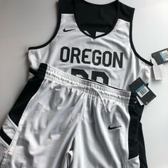 Nike Women Reversible Basketball Jerseys And Matching Shorts. Embroiled Nike Logos Both White And Black Reversible Side. Size M. Oregon. Number 00. Black And White. 100% Polyester. Jersey: Bust 40”. Length 26”. Shorts: Waist 31”-34”. Hip 44”. Length 16”. (Retail Price For The Same Nike Women’s Reversible Basketball Jersey Is $130 And Shorts Is $45) Wife Beater And Basketball Shorts, Basketball Jersey Outfit, Nike Logos, Nike Basketball Shorts, Jersey Outfit, Basketball Jerseys, Matching Shorts, Nike Basketball, Basketball Shorts