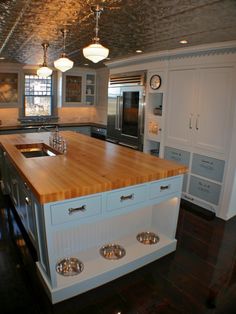 a large kitchen with an island in the middle