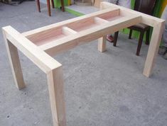 a wooden table sitting on top of a cement floor