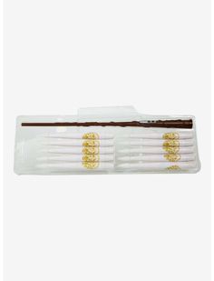 four toothbrushes in a package with gold designs on them, one is white and the other is brown