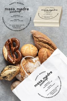 a bag full of different types of doughnuts and pastries on a table