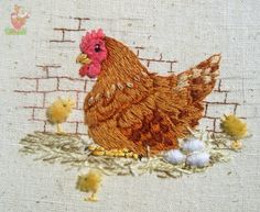 a close up of a chicken and chicks on a piece of cloth with some thread