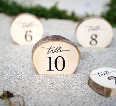 the table numbers are placed on wood slices