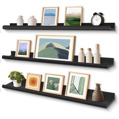 three black floating shelves with pictures and vases