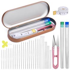 an assortment of sewing tools including needles, scissors and needle tips in a metal case