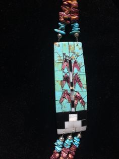 "Native American Indian, Santo Domingo Pueblo artist Raymond Rosetta's unusual handmade vintage multi-stone Corn inlay, multi-strand necklace, with turquoise, purple & orange spiny oyster, mother of pearl, jet, pin shell (backing) & sterling silver beads, including handmade stamped cones at the end before adjustable finish... Beautiful! 2 strands above Corn inlay pendants, 3 strands beneath... Corn inlay pendants are 3 3/8\" x 1 1/8\" x 3/16\" deep. 29-31\" long necklace (short strand) - Artisan Blue Inlay Necklaces, Artisan Turquoise Rectangular Jewelry, Unique Blue Necklace With Inlay, Artisan Blue Turquoise Multi-stone Necklace, Artisan Multi-stone Turquoise Necklace, Artisan Blue Multi-stone Turquoise Necklace, Rectangular Turquoise Jewelry For Collectors, Collectible Rectangular Turquoise Jewelry, Traditional Turquoise Inlay Necklace As Gift