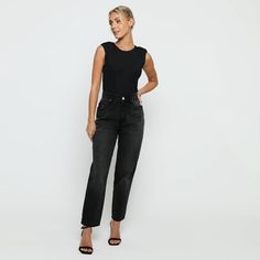 "Add some edge to your wardrobe with our black wash elasticated waist mom jeans. With a high waisted and straight leg fit, they'll make you look bold and more flattering. Made from soft denim fabric, they're also adjustable at the waist for a perfect fit. So go ahead and pair this beauty with cute tops and rock street style with confidence! Few amazing attributes: Black wash Denim fabric Straight hem High waisted Regular fitting Button and zip fly fastening Belt loops 5-pocket design Internal waist adjusters as product image Fabric: 100% Cotton Note: This Model is 5'9\" and Wears Size 8, To find the perfect fit for yourself check our Size Guide.   WOMEN'S HIGH WAISTED MOM JEANS Size = 6 - 18 Waist = 66cm - 90cm Hip = 98cm - 122cm Inside Leg = 77cm Waist is measured from All Around. Hip is Trendy Black Tapered Leg Jeans, Black High Waist Relaxed Fit Cropped Jeans, Black High Rise Cropped Jeans For Work, Black High-rise Cropped Jeans For Work, Black Denim Cropped Jeans For Work, Trendy High-rise Black Cropped Jeans, Trendy Black High-rise Cropped Jeans, Trendy Black Straight Jeans, Black Relaxed Fit Cropped Jeans With Tapered Leg