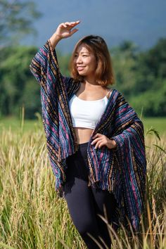 "YARN: 💯 % Cotton Woven With its vibrant colors and playful tassels, this poncho is perfect for a festival or a day out with friends. It's lightweight and comfortable, so you'll stay cozy all day long. Size : One size fits All  * Width 49'' *Length : 30'' * Model chest 32\"                Waist 24\"                Hip   34\" *combined height is 174.cm                                                     RETURN AND REFUND POLICY                                                                                Thanks for Shopping at YasminJasmine. 🙏 🌸* Returns are available IF AND ONLY IF you received a different item from what you ordered, damaged goods. 🌸* You have 7 Days to return an item from the date you received it. 🌸* To be eligible for a return, your item must be unused and in the s Casual Beach Shawl For Fall, Casual Fall Beach Shawl, Beach Poncho With Batwing Sleeve For Fall, Batwing Sleeve Poncho For Beach In Fall, Casual One Size Shawl For Festivals, Beach Cape Shawl For Fall, Bohemian Blue Cape Outerwear, Bohemian Blue Cape-style Outerwear, One Size Shawl Outerwear For Festivals