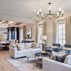 a living room filled with furniture and a chandelier