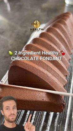 a man points to a chocolate fondant on a conveyor belt with the words, 2 ingredient healthy chocolate fondant