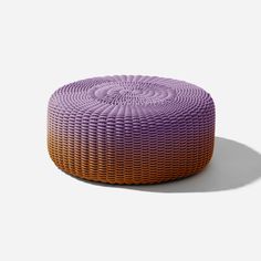 an orange and purple round ottoman on a white background