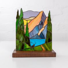 Stained glass panel of bear in forest on a wooden stand is a cute desk decoration for your home or office 🏠 Bright colors of stained glass nature panel wonderfully vibrate in the sun and fascinate with their shades. This home decor will be a great gift to make someone smile every day 💜✨ This product is created according to the L.C. Tiffany technique of copper foil, during which we refer to only the top-quality materials, such as: • Stained Glass • Tin• Copper Foil• Black Patina ⠀ We advise you Forest Table Decor, Animal In The Forest, Stained Glass Nature, Bear In Forest, Deer In Forest, Glass Table Decor, Stained Glass Table, Pic Candle, Mountain Pictures