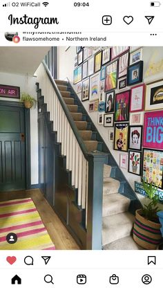 a staircase with pictures on the wall next to it