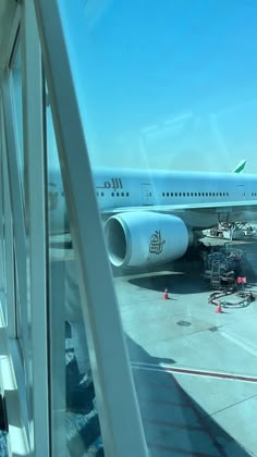 an airplane sitting on the tarmac at an airport with its door open to let passengers board