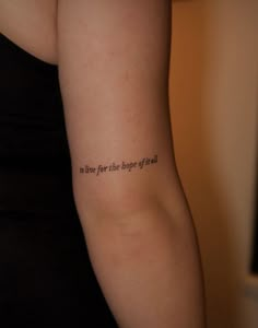 a woman with a tattoo on her arm that says to live for the biggest effect