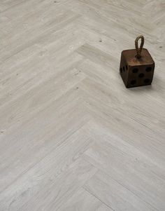 a wooden block sitting on top of a white floor