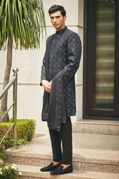 Black sherwani with floral Mughal chikankari embroidery and sequin highlights. Comes with matching dupatta, short kurta and pant.
Components: 4
Pattern: Embroidered
Type Of Work: Chikankari, Sequins
Neckline: Mandarin
Sleeve Type: Straight Full
Fabric: Sherwani and Dupatta- Georgette, Kurta and Pant- Terrywool
Color: Black
Other Details: 
Model height: 6ft, wearing size M
Occasion: Cocktail and Reception - Aza Fashions Festive Designer Sherwani With Chikankari Embroidery, Eid Traditional Sherwani With Chikankari Embroidery, Festive Designer Kurta With Chikankari Embroidery, Designer Kurta With Mirror Work For Eid, Designer Eid Kurta With Mirror Work, Festive Sherwani With Chikankari Embroidery For Eid, Eid Festive Sherwani With Chikankari Embroidery, Festive Eid Sherwani With Chikankari Embroidery, Eid Bandhgala With Chikankari Embroidery