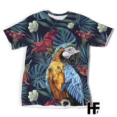 a t - shirt with a colorful parrot on it's chest and flowers in the background