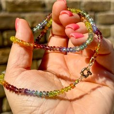 This rainbow necklace combines multiple colors of Sapphire along with Ruby, Tsavorite Garnet, Fanta Garnet, Tourmaline, Citrine, Tanzanite, Diopside and Zircon. It's 21" long and knotted by hand on a custom-dyed lime green silk cord and finished with solid 14k findings and an 8mm sailor clasp perfect for hanging charms, lockets, or talismans. This necklace is perfect for lovers of the colorful and quirky who also like a bit of luxury in the mix. . This necklace is one of a kind, and while I may Rainbow Rondelle Necklace For Gift, Rainbow Rondelle Necklace Gift, Multicolor Single Strand Gemstones As A Gift, Rainbow Single Strand Round Necklace, Rainbow Round Single Strand Necklace, Rainbow Round Single Strand Jewelry, Rainbow Colored Single Strand Round Jewelry, Multicolor Multi-stone Rondelle Jewelry, Fine Jewelry Multicolor Gemstones For Jewelry Making