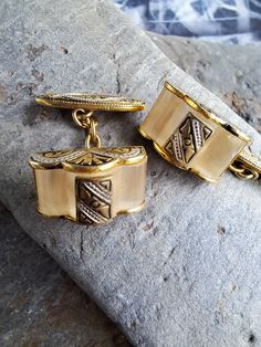 This is a lovley pair of vintage damascene cufflinks.They were made in the 1960s era in Toledo,Spain.They feature the typical damascene gold and black ornate decoration with faux glass tortoiseshell.The cufflinks are in very good condition.The top is 1.5 cm wide x1 cm.Please study the pictures.They come with a velvet drawstring bag. Antique Engraved Cufflinks For Formal Wear, Antique Engraved Cufflinks For Formal Occasions, Antique Hallmarked Cufflinks For Formal Wear, Antique Hallmarked Cufflinks For Formal Occasion, Antique Cufflinks For Anniversary, Antique Hallmarked Cufflinks For Wedding, Hallmarked Antique Cufflinks For Wedding, Antique Clip-on Jewelry As Gift, Antique Cufflinks For Formal Wear