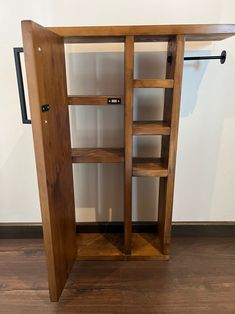 a wooden shelf with two open doors on it