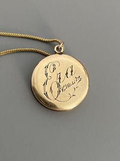 "Weight: 11.9g Dimensions: 1\" round, 18\" chain Hallmarks: Makers mark L & M Although these lockets were patented in the year 1902, this particular locket states on its backside that it is from the 'class of '12' dating it to a decade later. This is a very unique locket in that it has 3 windows and folds like an accordion. All bezels are present and the two clear windows inside the front and back covers are still present. The locket measures 1\" round and comes on an 18\" GF chain. Very lig Antique Medallion Locket Necklace Stamped 14k, Victorian Round Locket Necklace Stamped 14k, Vintage 14k Gold Locket Necklace, Vintage 14k Gold Locket Necklace Stamped 14k, Victorian Stamped Gold Jewelry, Victorian Jewelry With Coin Pendant, Victorian Style Medallion Coin Pendant Jewelry, Vintage 14k Gold Coin Pendant Jewelry, Victorian Necklace With Coin Pendant For Formal Occasions